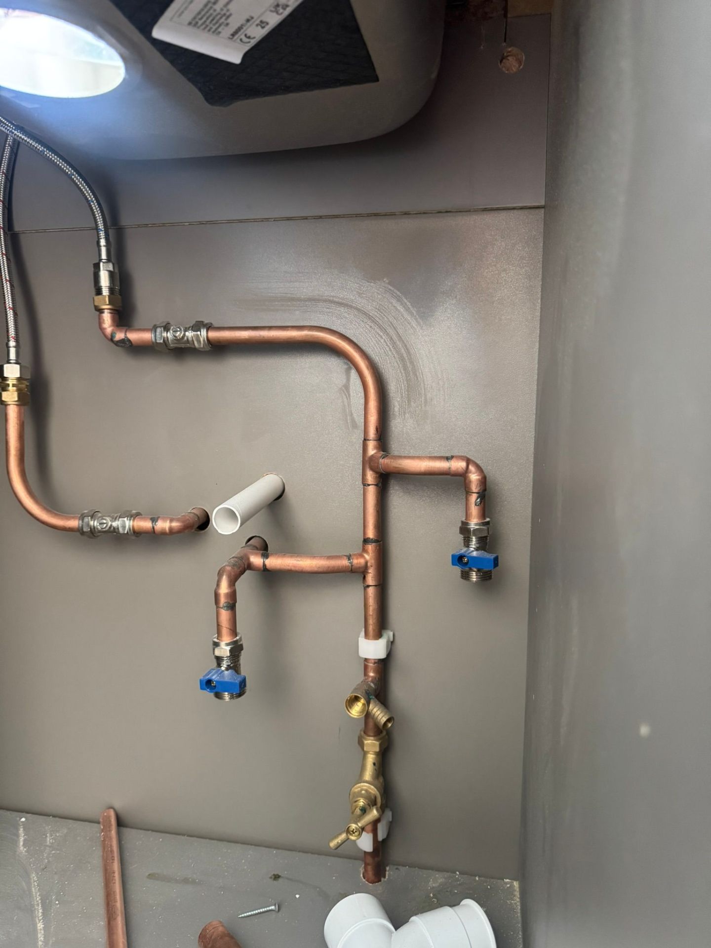 First-fix wet underfloor heating manifold and pipe layout on foil insulation boards