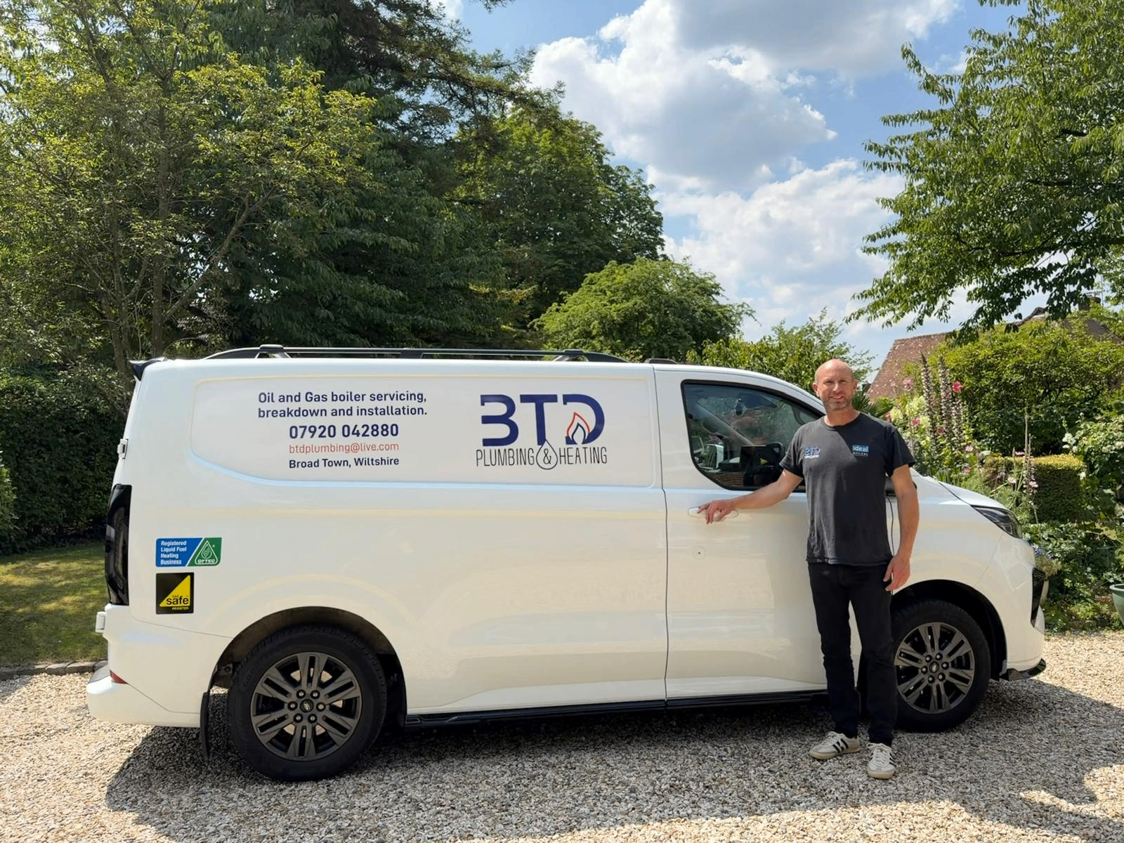 Ben Davis of BTD Plumbing & Heating with his signed-written oil and gas boiler service van in Broad Town, Wiltshire