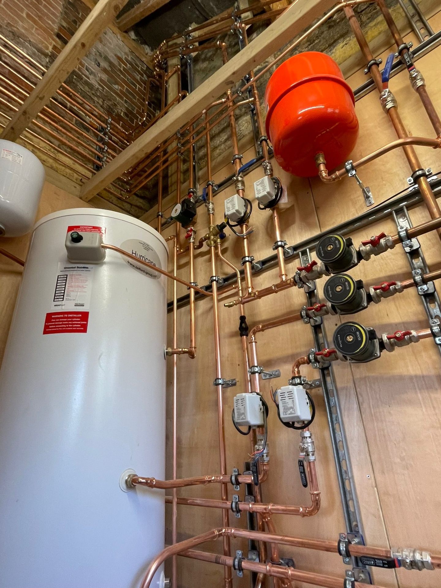 Zoned central heating manifold with low-loss header and multiple circulator pumps installed by BTD